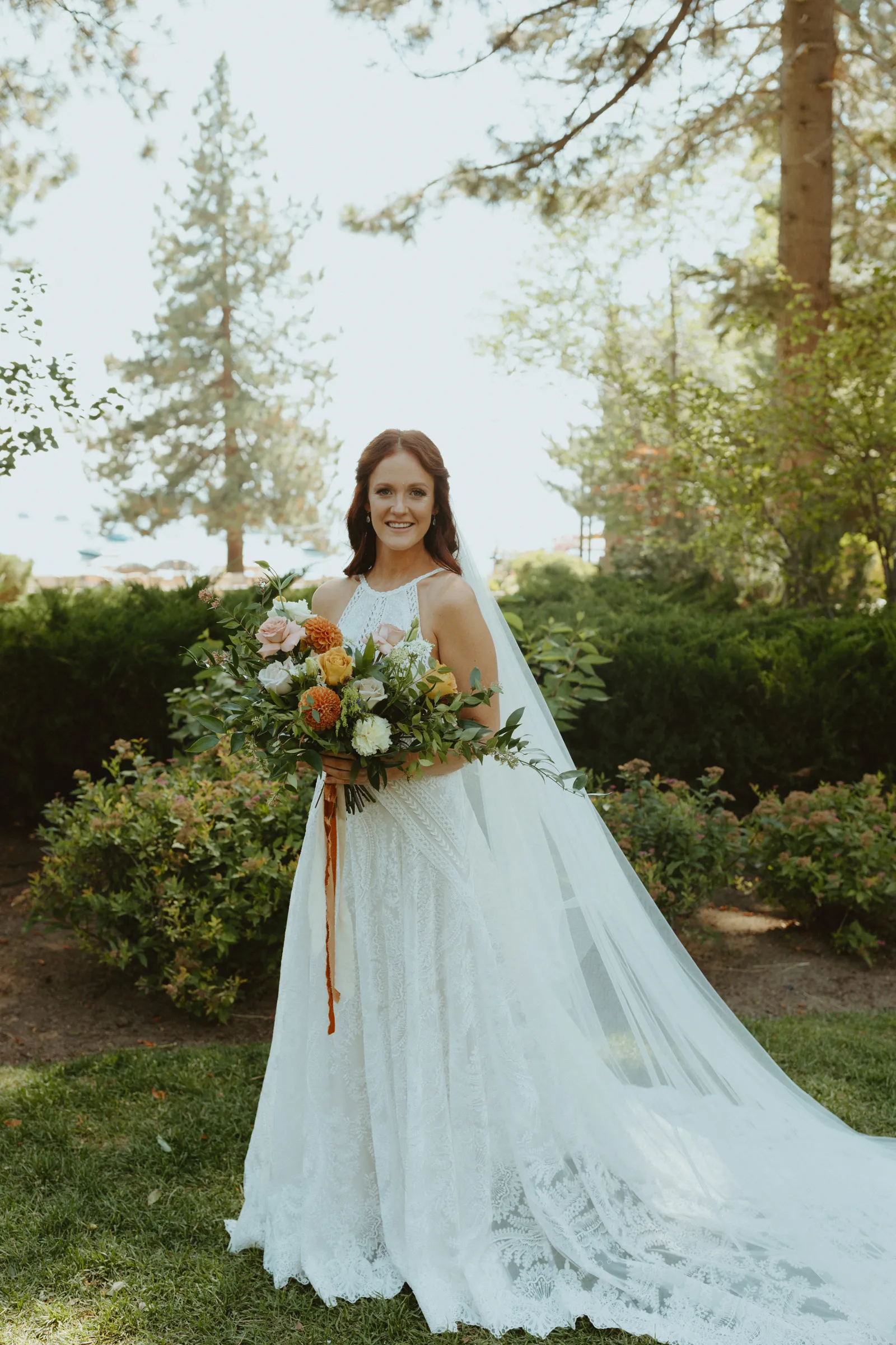 Bride posing on her own for the camera in the woods.