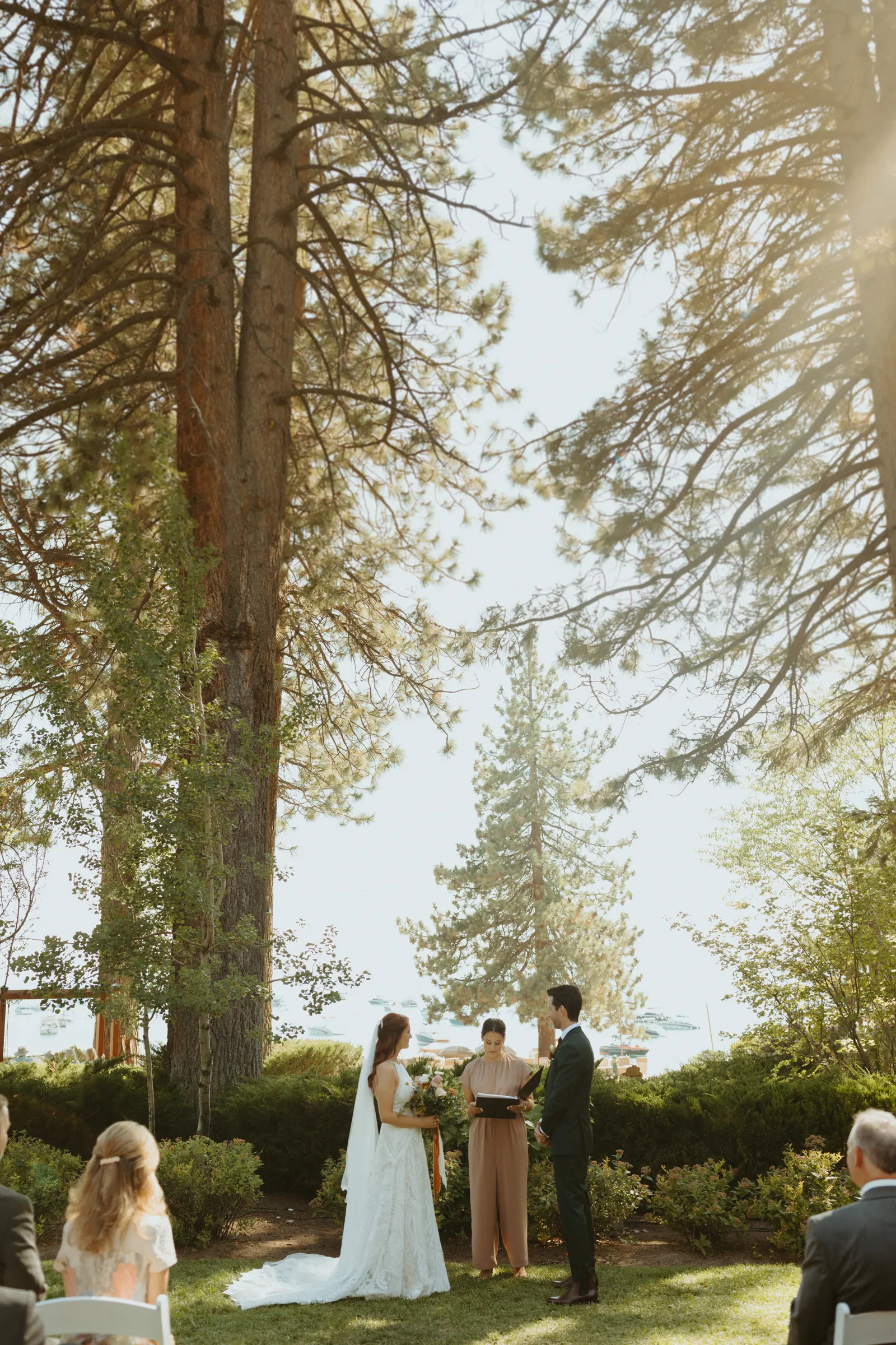 Bride and groom holding hands outside at the altar.