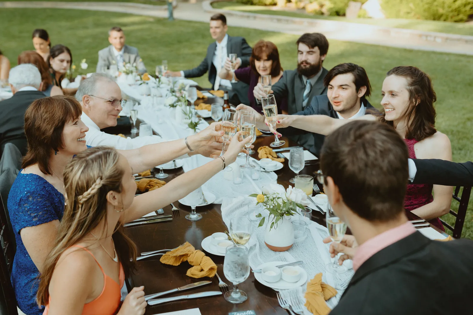 Guests cheersing to the bride and groom after the wedding ceremony.