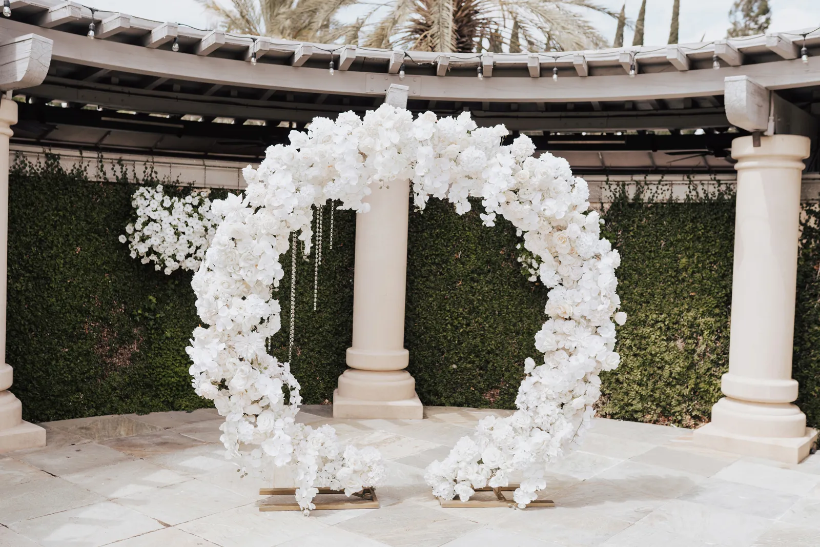 White, circular floral wedding arch.