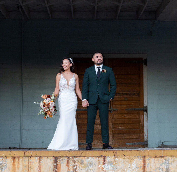 Newlyweds holding hands and taking wedding photos at The Willow Ballroom.