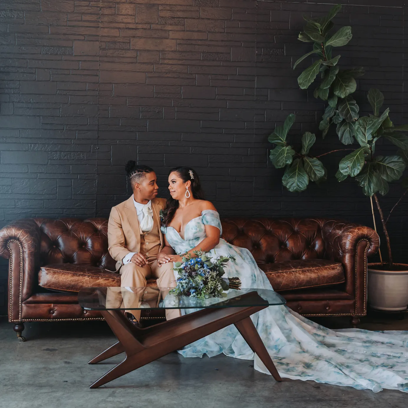 Newlyweds taking wedding photos at The BLOC Venue on a couch.