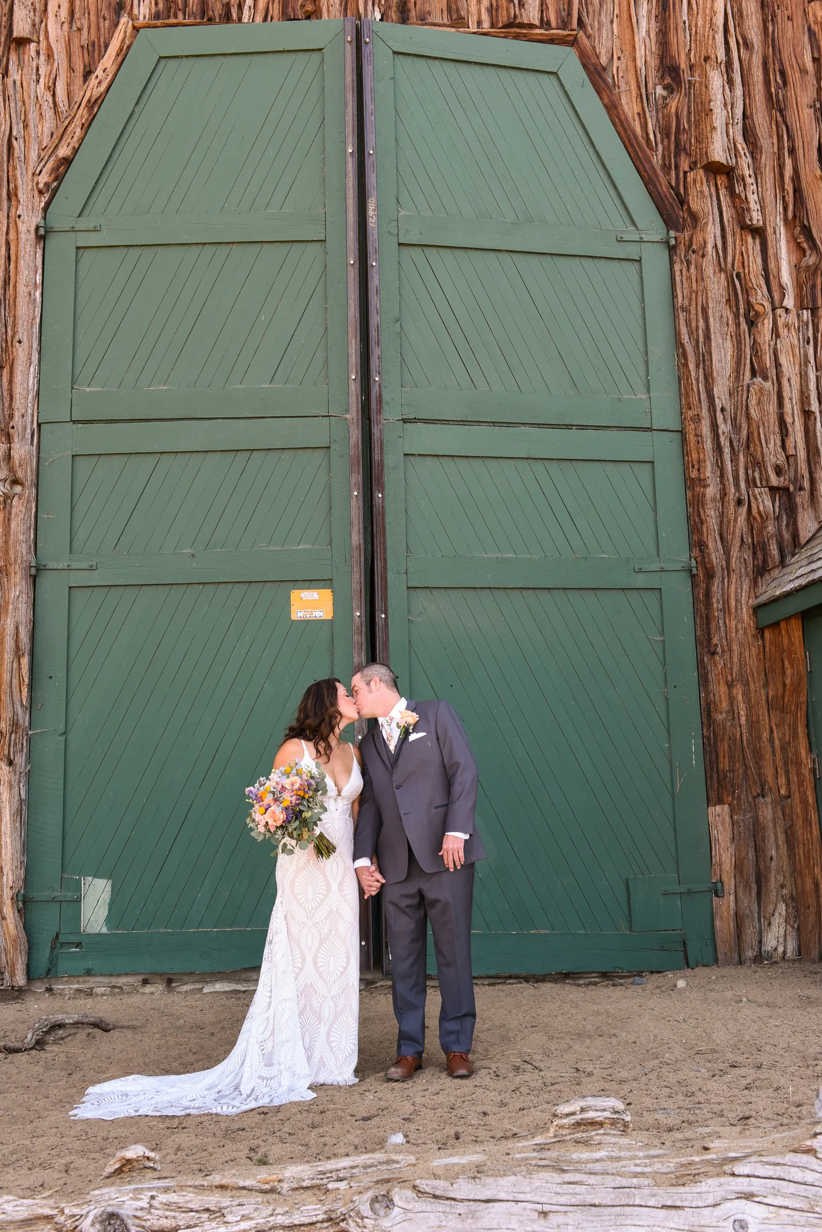 Newlyweds taking kissing photos with Shoop's Photography.