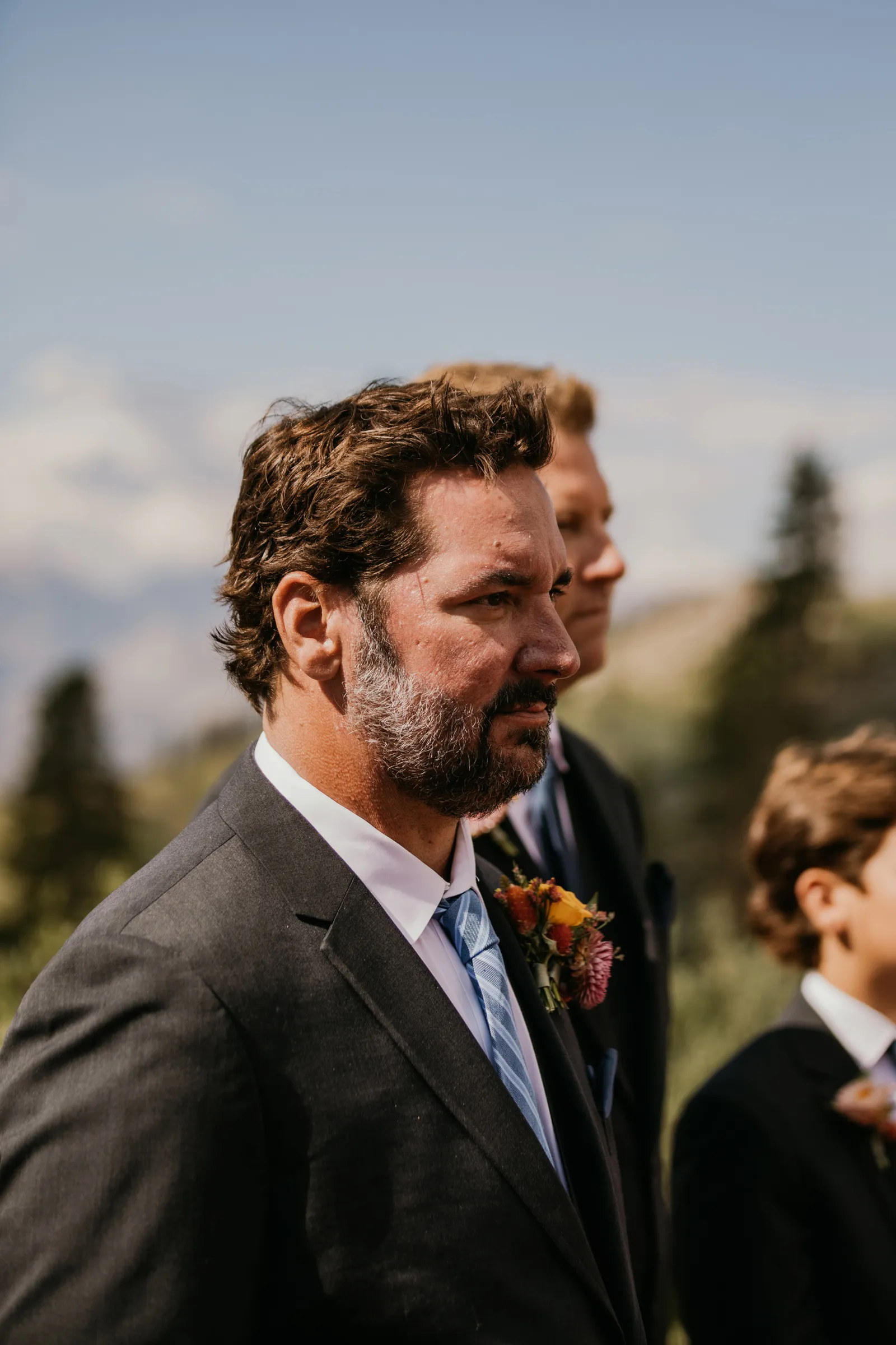 Groom watching his bride walk down the aisle.