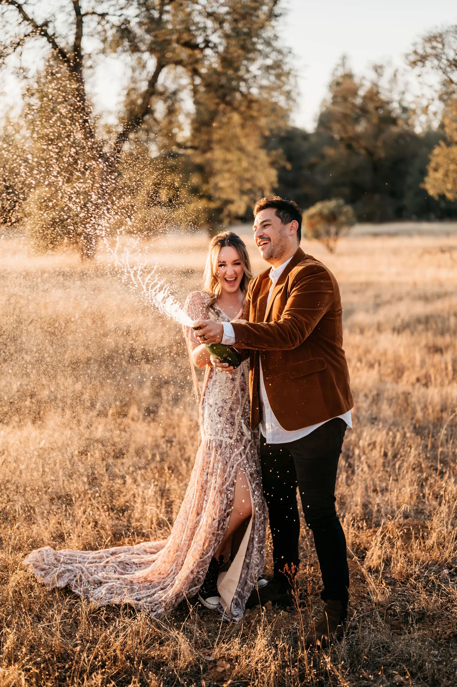 Bride and groom spraying champagne.