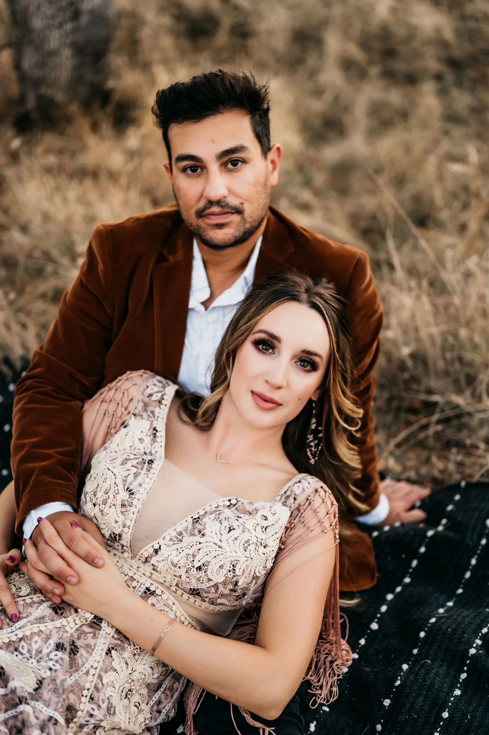 Bride and groom laying down for their eclectic boho shoot.