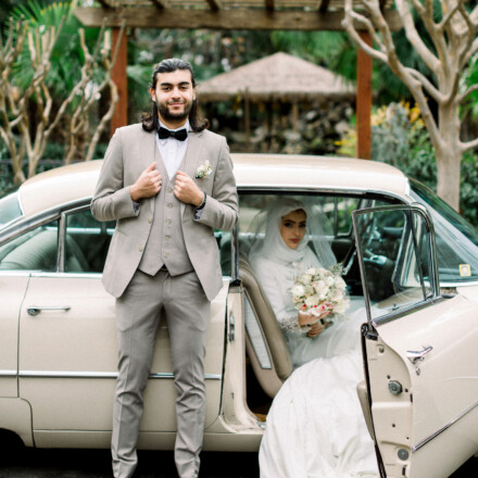 Bride and groom about to leave a vintage car at The Palms in Chico wedding venue.