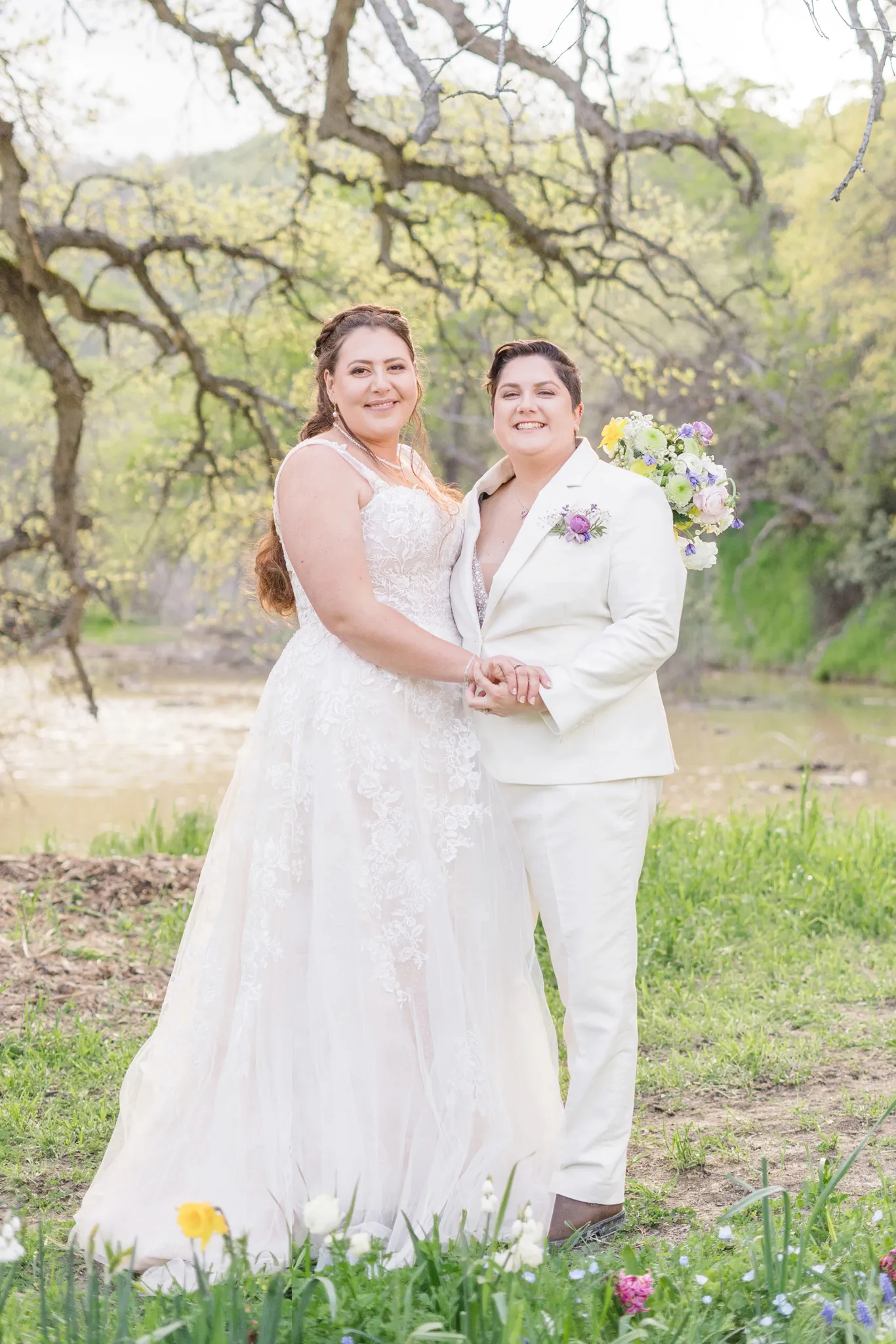 Hannah and Margaret posing at their scenic outdoor wedding ceremony.