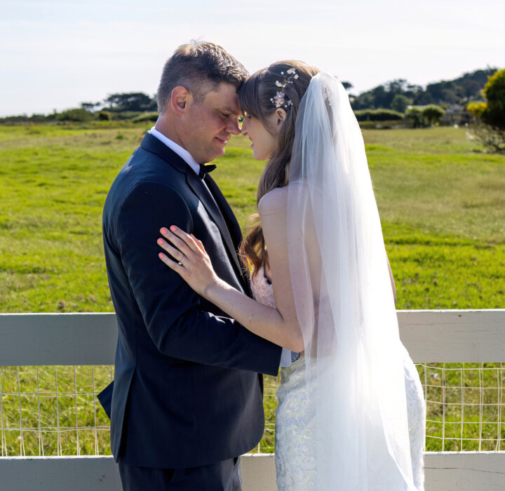 Newlyweds taking wedding photos at their elegant outdoor Carmel wedding.