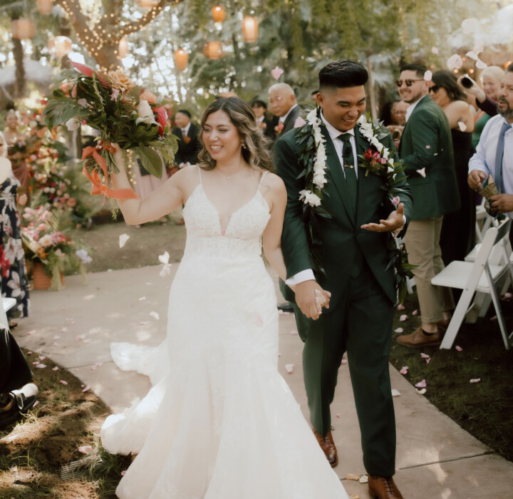 Newlyweds walking down the aisle at their beautiful, multicultural wedding ceremony at The Palms.