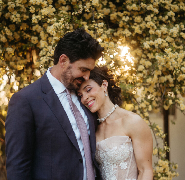 Newlyweds posing at their outdoor, Japanese-inspired featured real wedding.