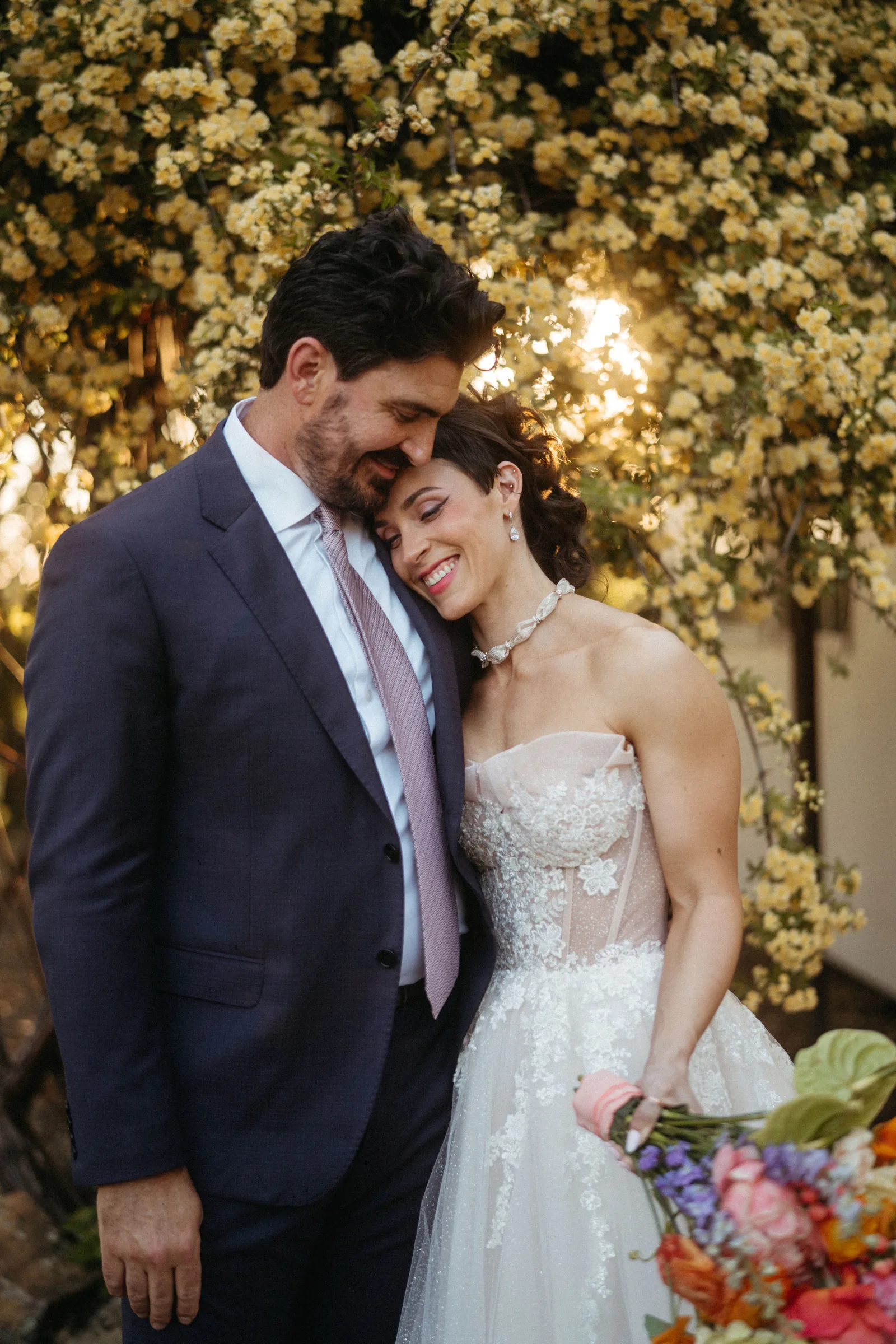 Newlyweds posing at their outdoor, Japanese-inspired featured real wedding.