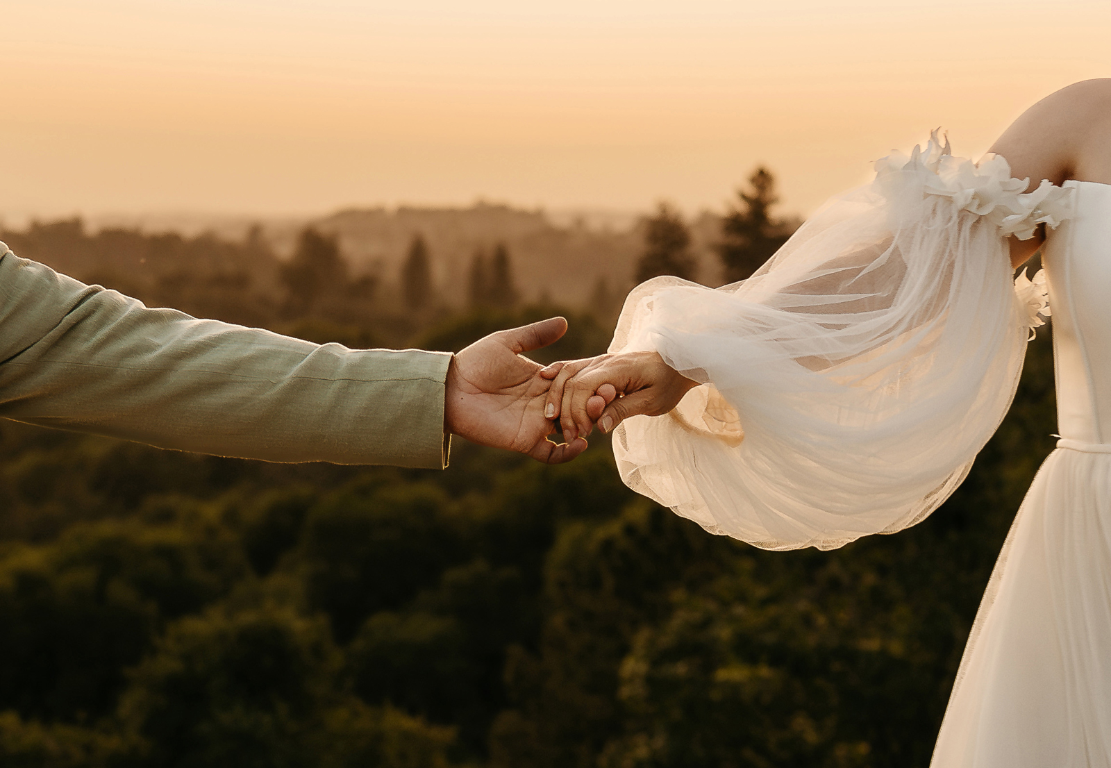 Newlyweds holding hands at Rubidoux Ridge Vineyard.