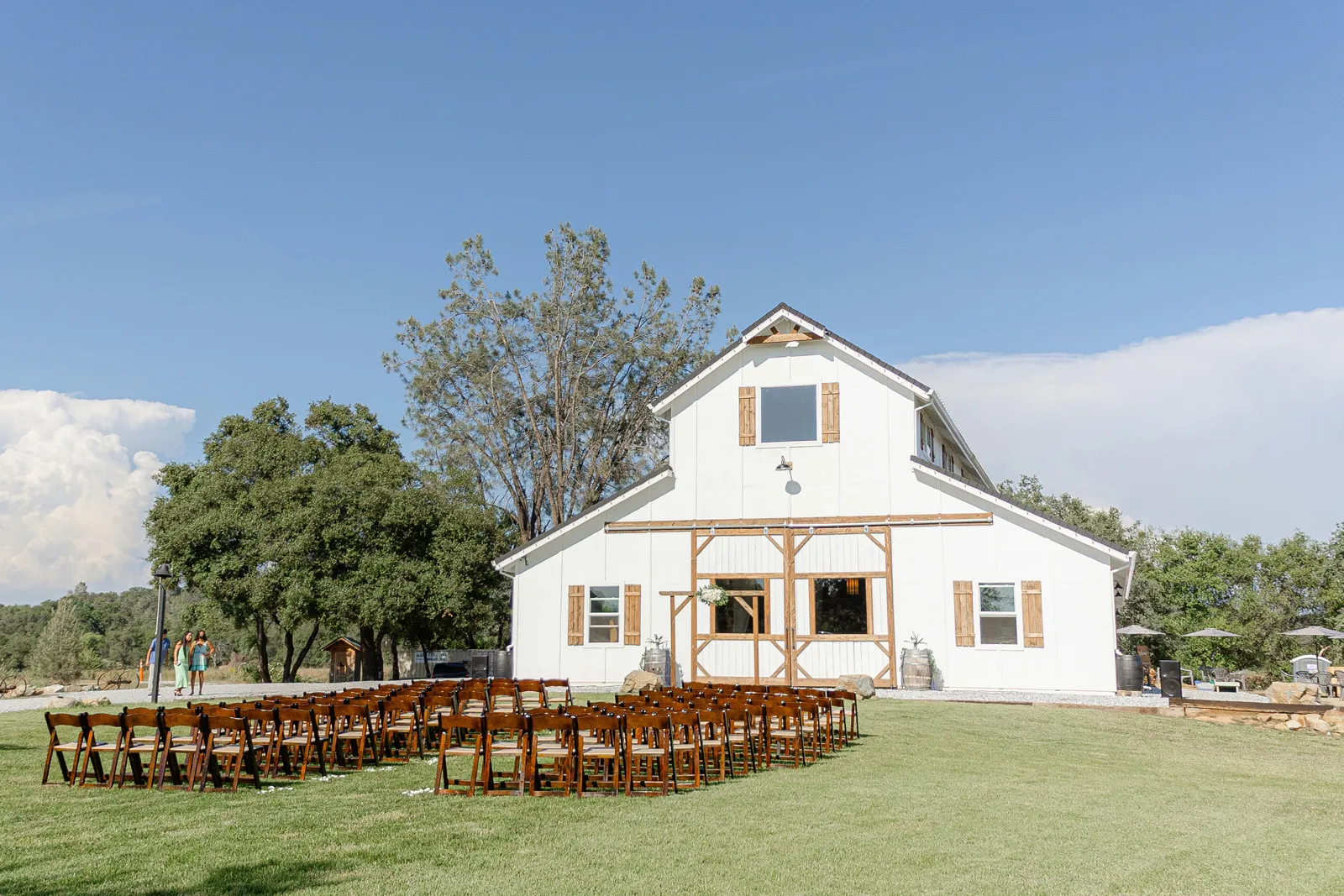 White barn wedding venue next to a pond.