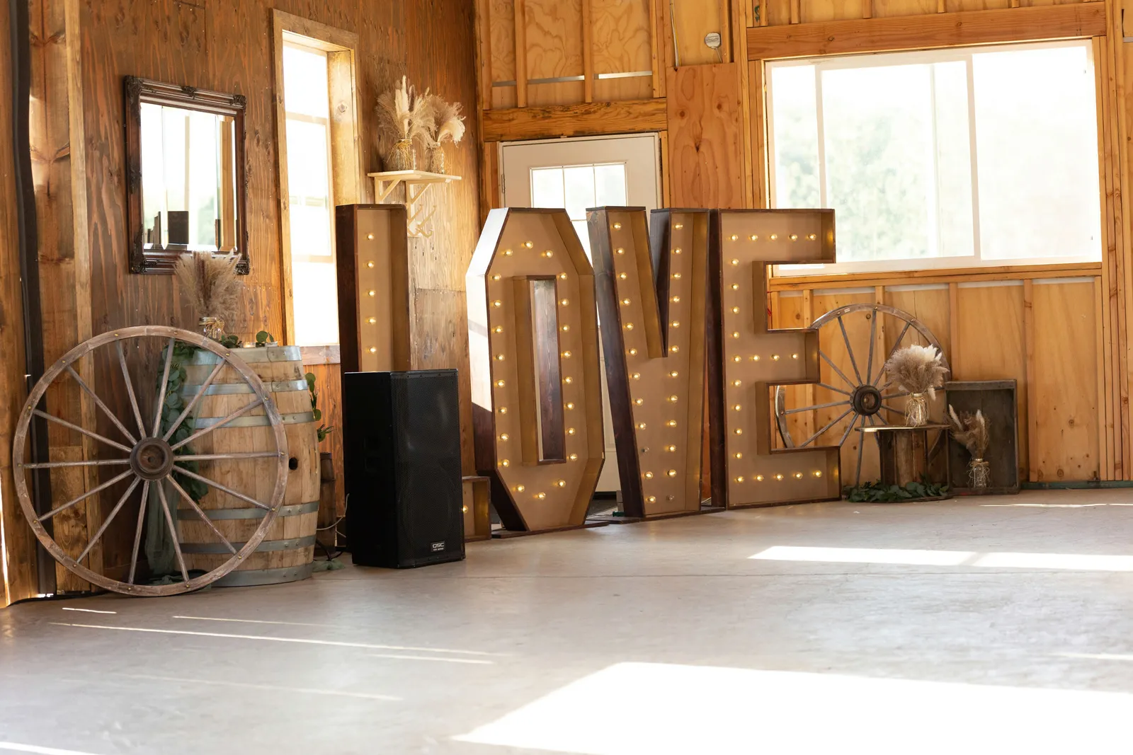 Giant "LOVE" sign at the elegant outdoor barn wedding reception.