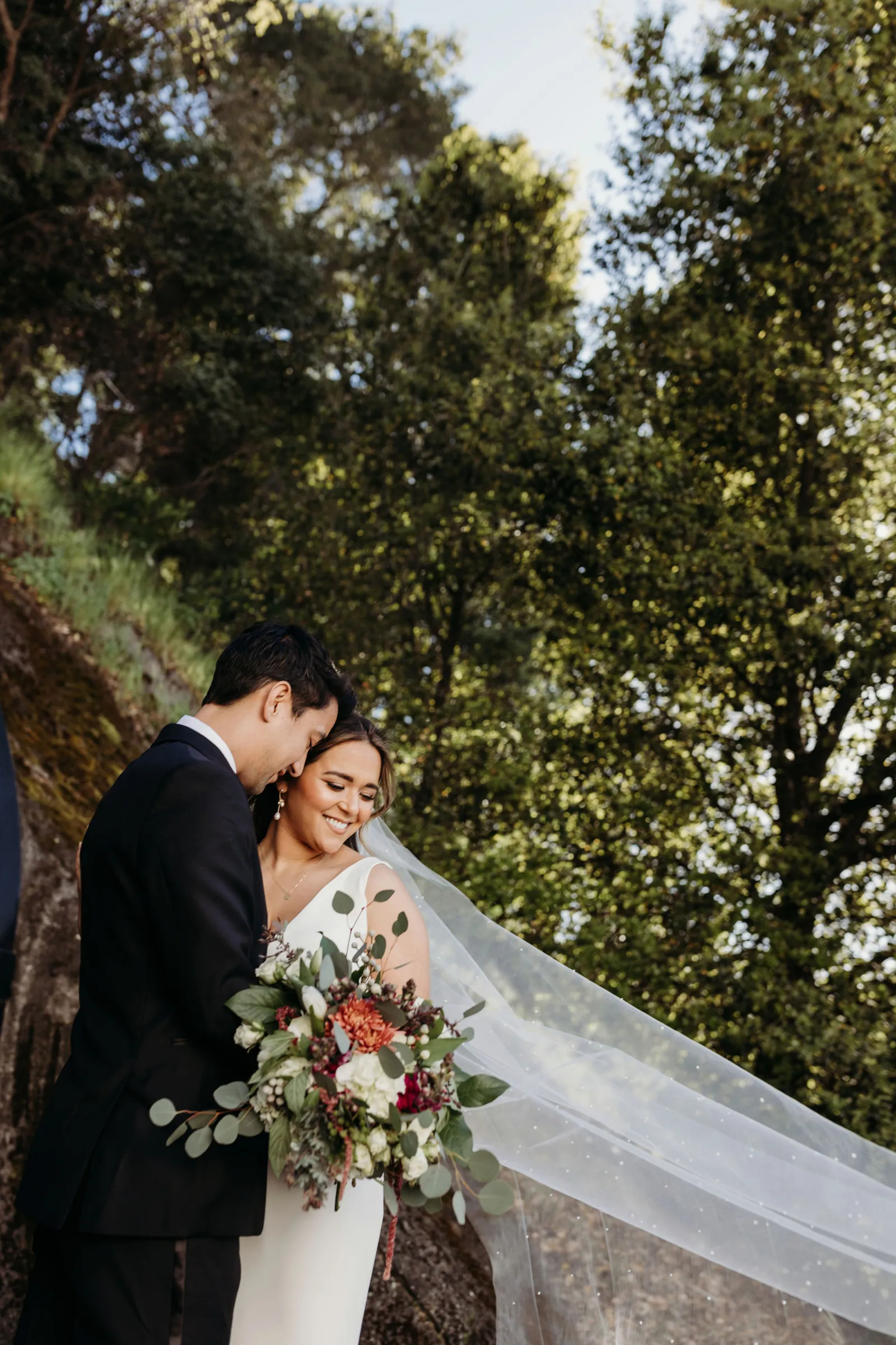 Newlyweds posing together at their elegant winery wedding.