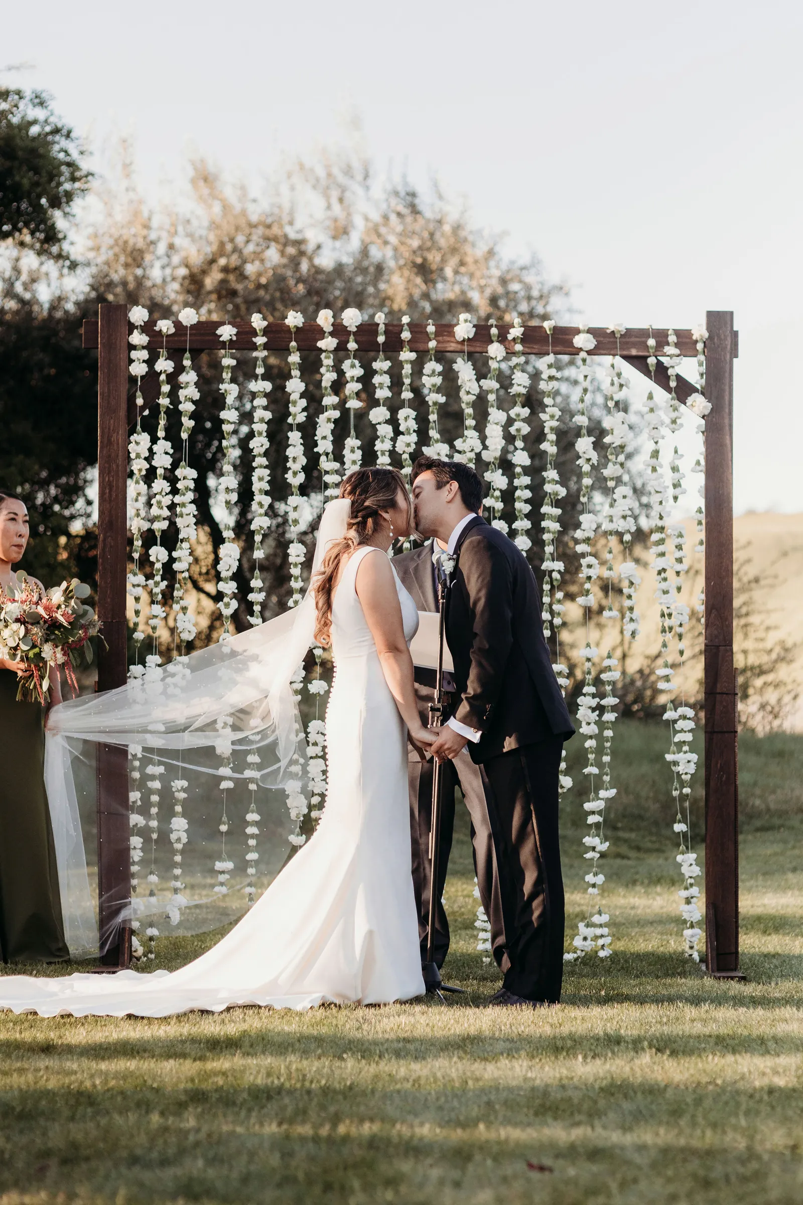 Newlyweds kissing at the end of their wedding ceremony.