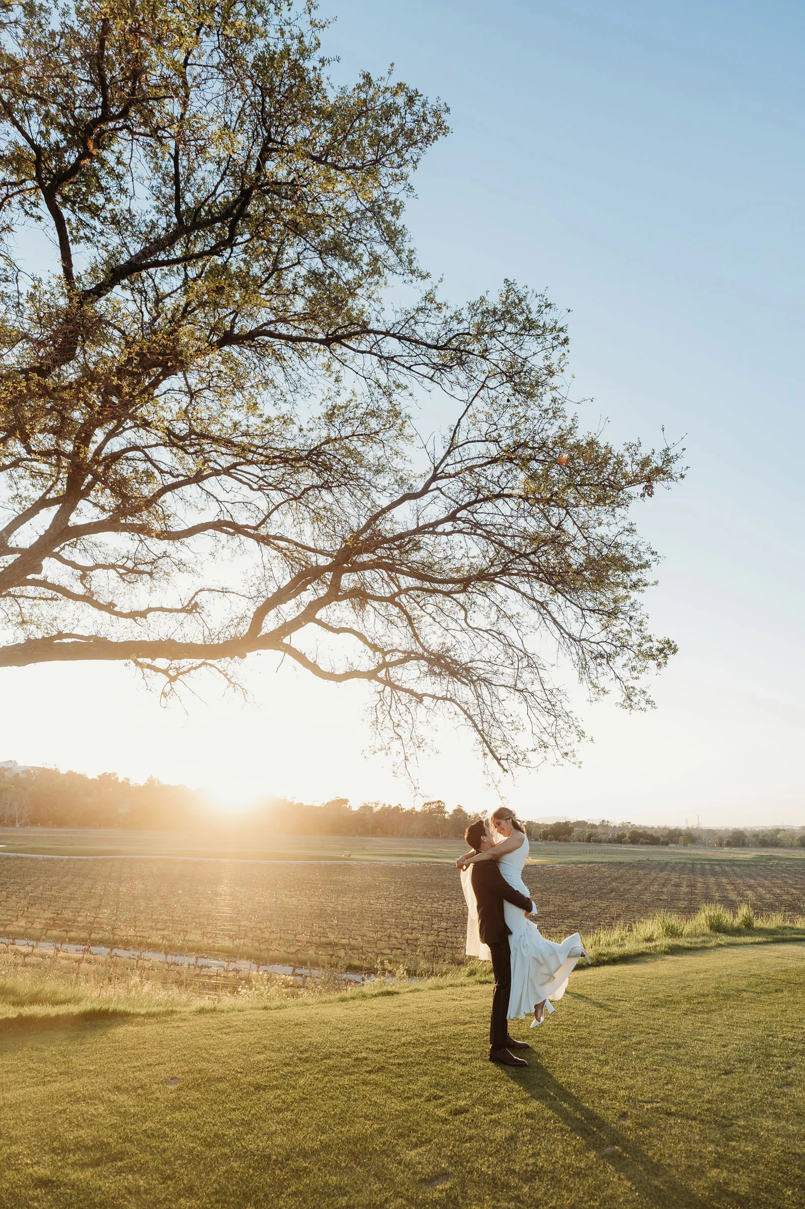 Newlyweds celebrating and taking wedding photos at Wente Winery.