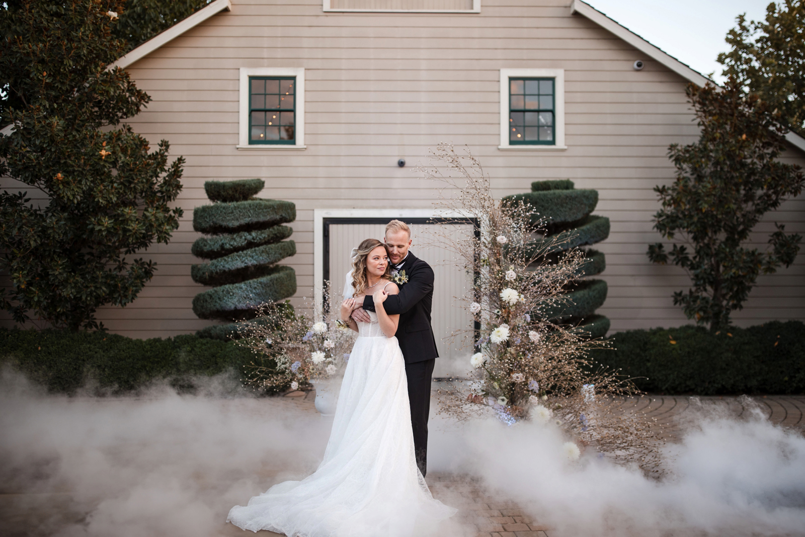 Bride and groom dancing together at Scribner Bend Vinayards wedding venue with a mist machine.