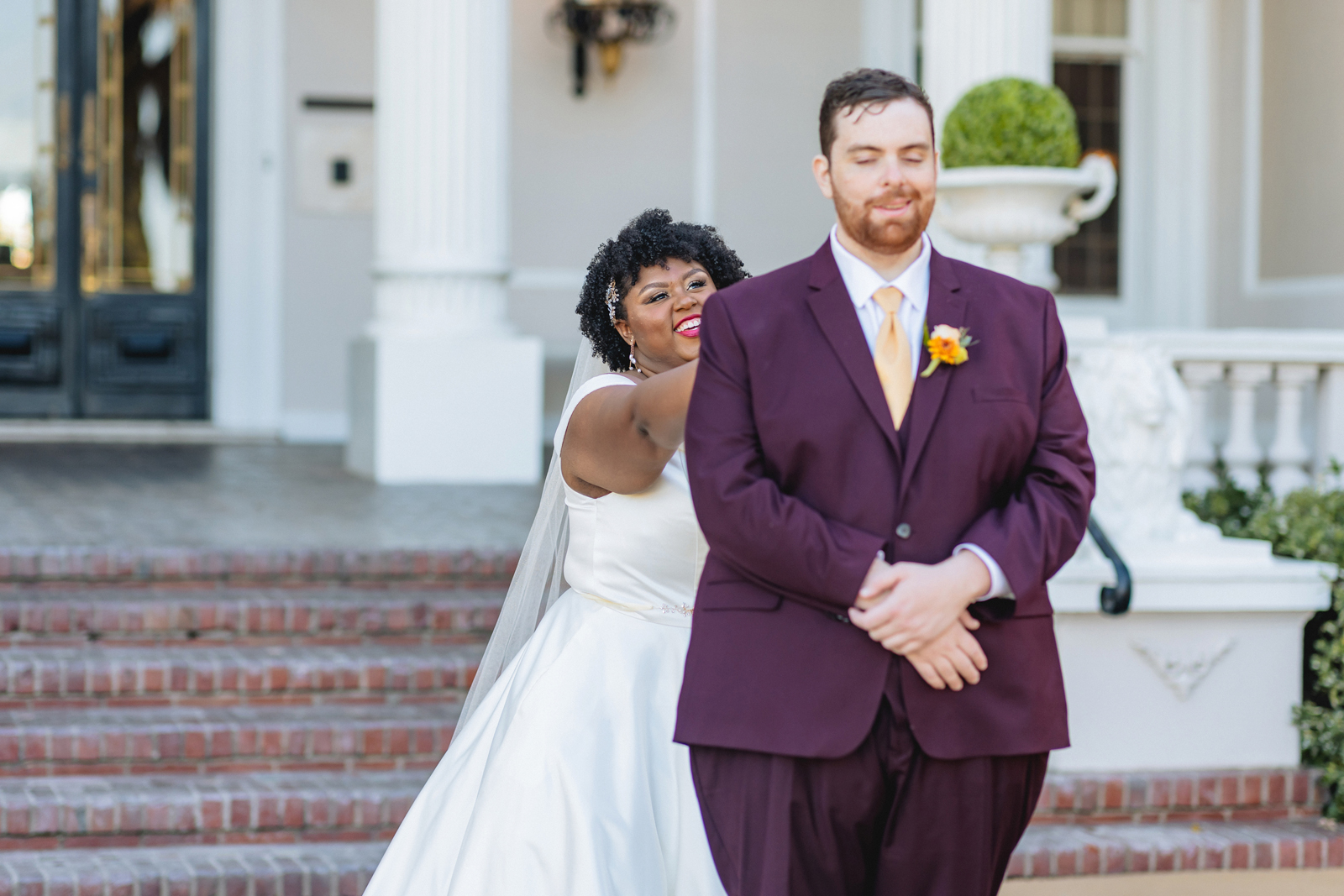 Bride and groom doing their first look together at the Grand Island Mansion wedding venue.