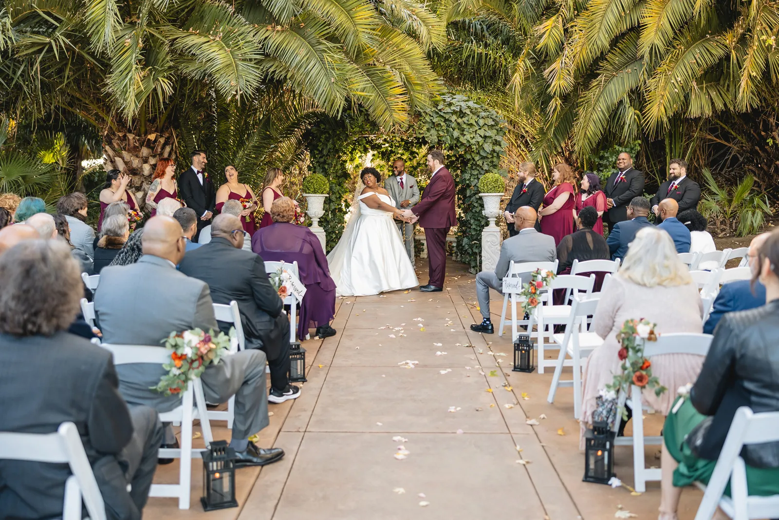 Bride and groom holding hands at the altar at their beautiful mansion wedding.