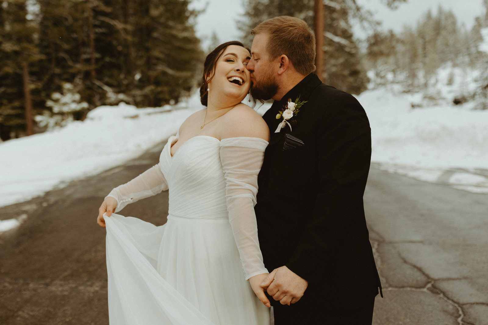 Bride and groom taking wedding photos together at their ski lodge wedding venue.