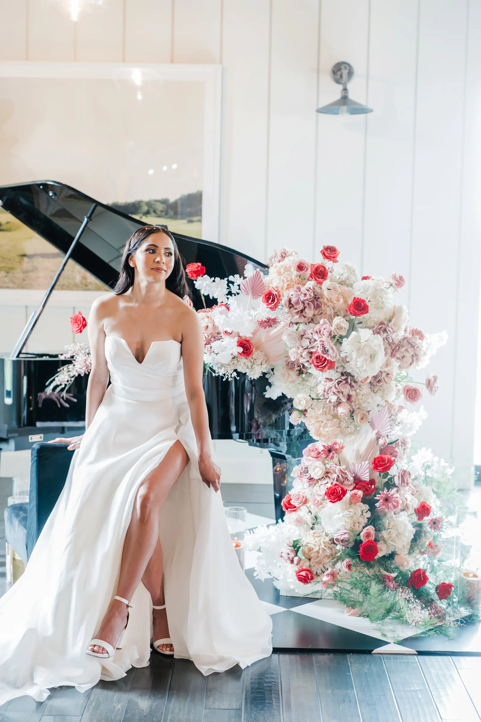 Bride posing against a chic grand piano at her Elegant wedding-inspiration styled shoot at The Ranch at Lone Oak Longhorns wedding venue.